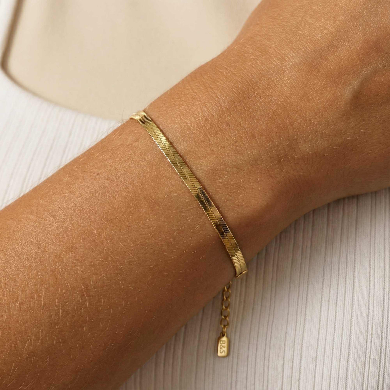Kauai Herringbone Bracelet by Brother & Sisters features sleek herringbone design in liquid-gold shimmer.