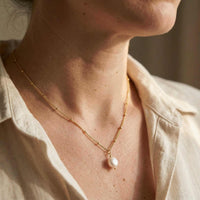 Thumbnail for Pearl Drop Necklace worn elegantly, featuring an 8mm freshwater baroque pearl by Brother & Sisters.