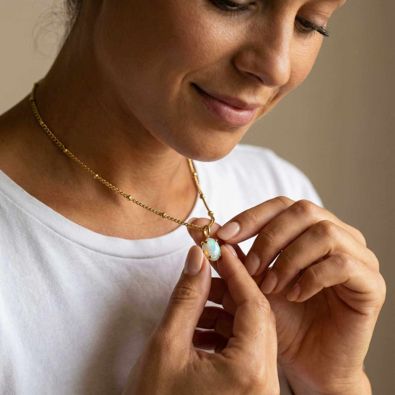 Opal Pendant Necklace worn by a woman, showcasing a real AAA-grade opal set in gold prongs by Brother & Sisters.