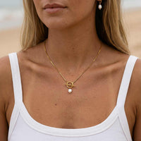 Thumbnail for La Isla Pearl Toggle Necklace featuring a sculptural gold toggle and freshwater pearl by Brother & Sisters.