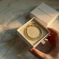 Thumbnail for Ios Layered Bracelet in a gift box by Brother & Sisters, showcasing gold herringbone and twisted rope textures.
