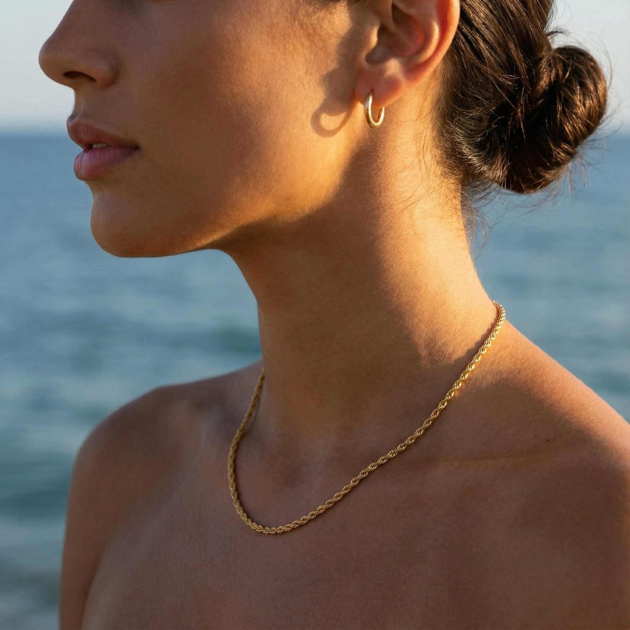 Rope Chain Necklace worn by a model at the beach, showcasing its classic twisted texture, by Brother & Sisters.