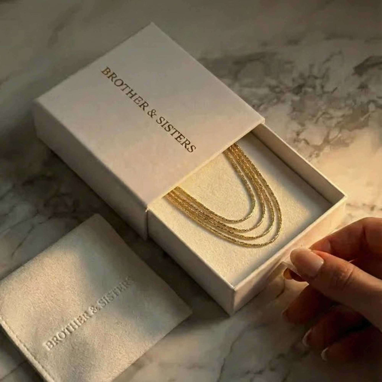 Riviera Layered Choker in a gift box by Brother & Sisters, featuring four delicate chains for effortless layered style.