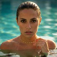 Thumbnail for White Beaded Choker worn by a model in water, featuring delicate white enamel beads, by Brother & Sisters.