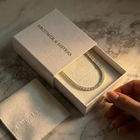 Thumbnail for Isolde Tennis Necklace displayed in a Brother & Sisters box, showcasing its 3mm diamond simulants and 18K gold.