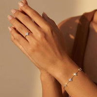 Thumbnail for Crystal Flower Ring worn on a hand with a delicate bracelet by Brother & Sisters, featuring brilliant-cut zirconia stones.