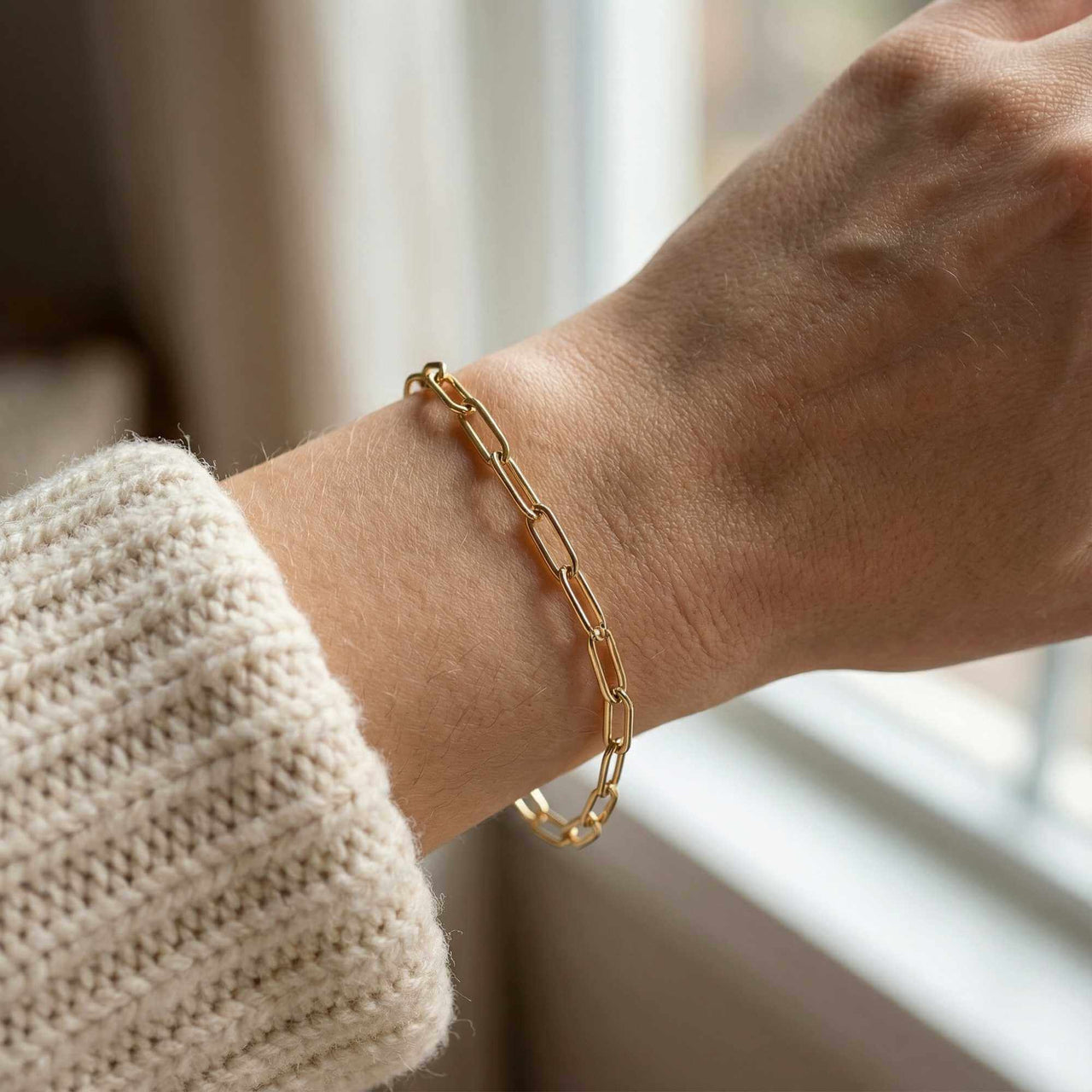 Hand wearing a gold link bracelet from Brother & Sisters, showcasing elegance and style for everyday wear.