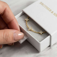 Thumbnail for Crystal Flower Bracelet by Brother & Sisters, featuring five crystal flowers in a gift box.