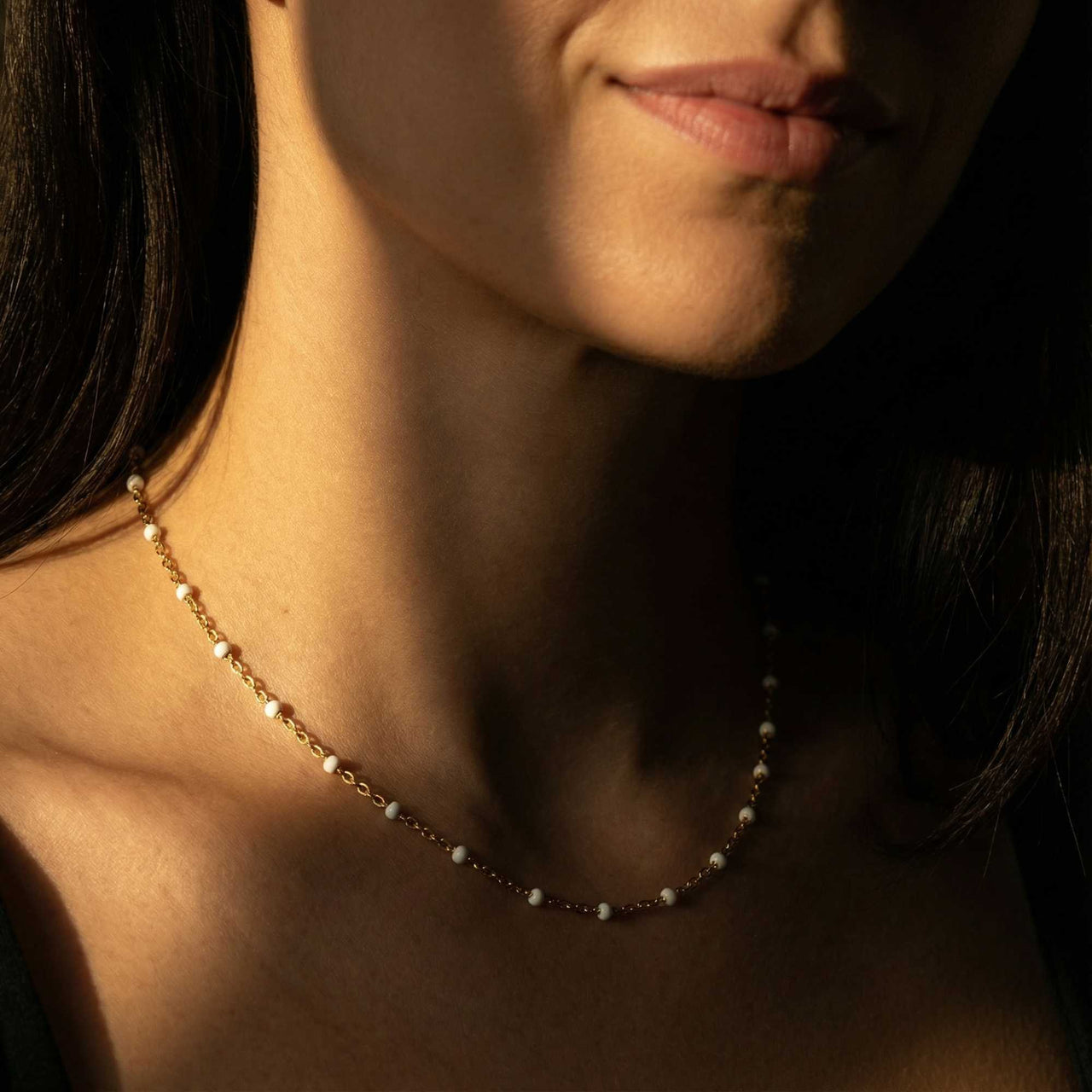 White Beaded Choker featuring tiny white enamel beads by Brother & Sisters, worn by a model.