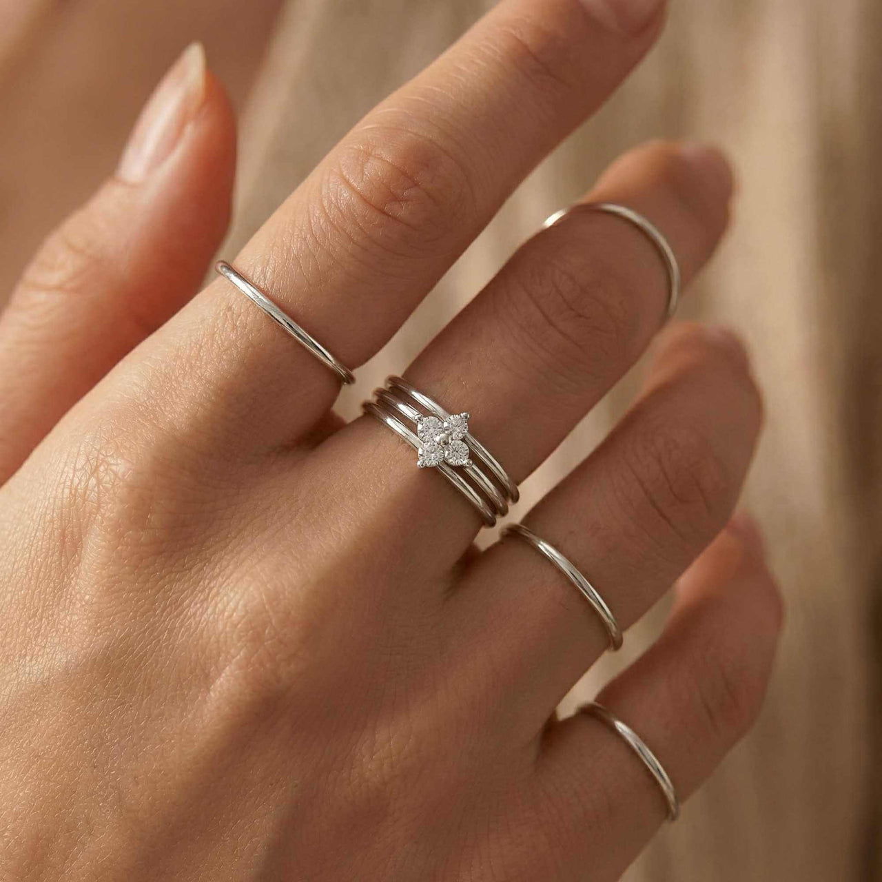 Crystal Flower Ring with delicate band and sparkling zirconia stones on a hand by Brother & Sisters.