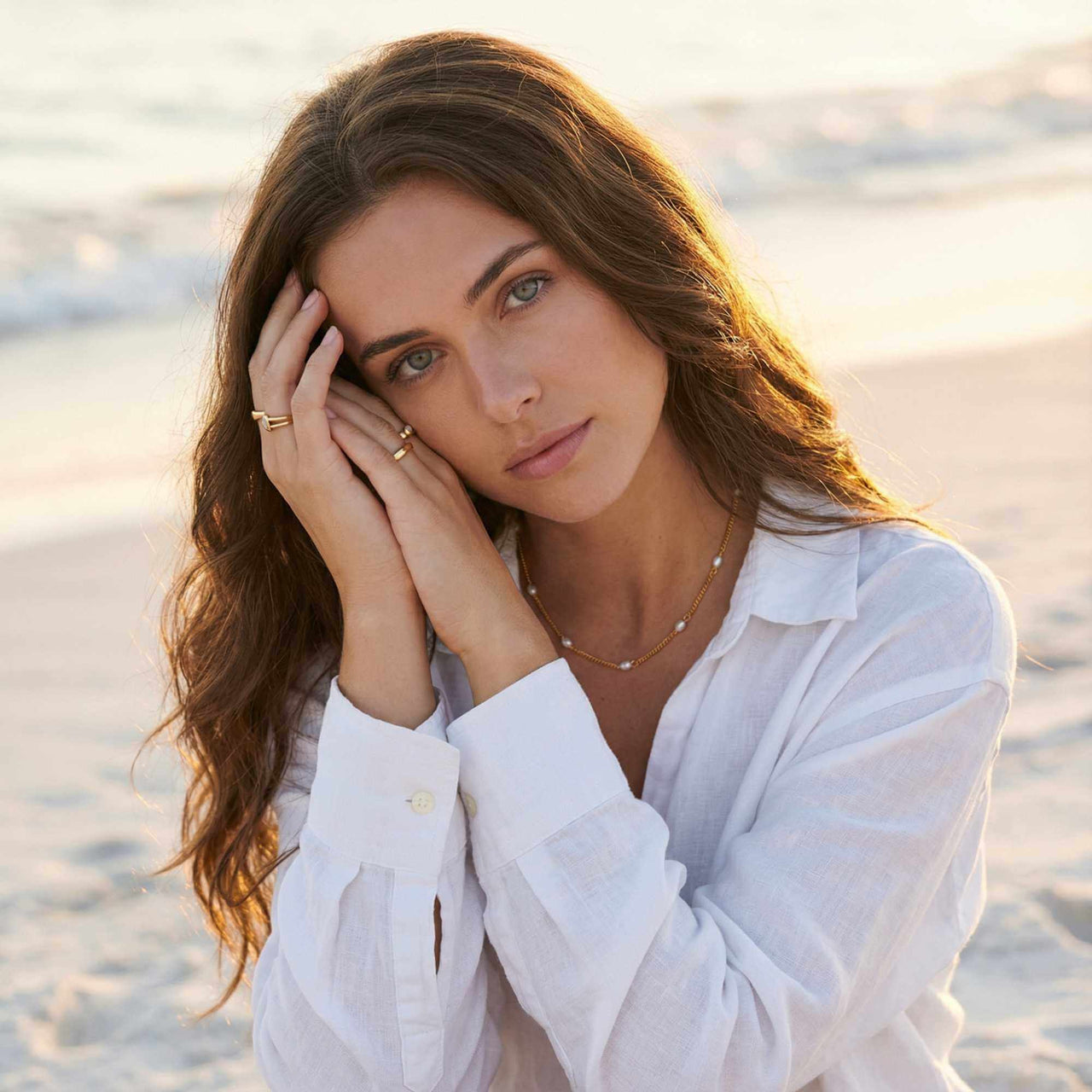 Dainty Pearl Choker worn by model on the beach, featuring tiny freshwater pearls on a delicate gold chain by Brother & Sisters.