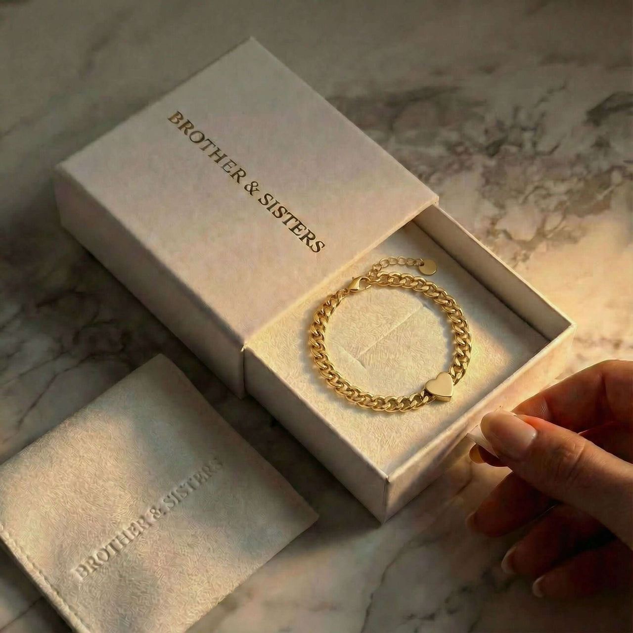 Love Couple Bracelet in a gift box by Brother & Sisters, featuring a polished heart and bold Cuban link chain.