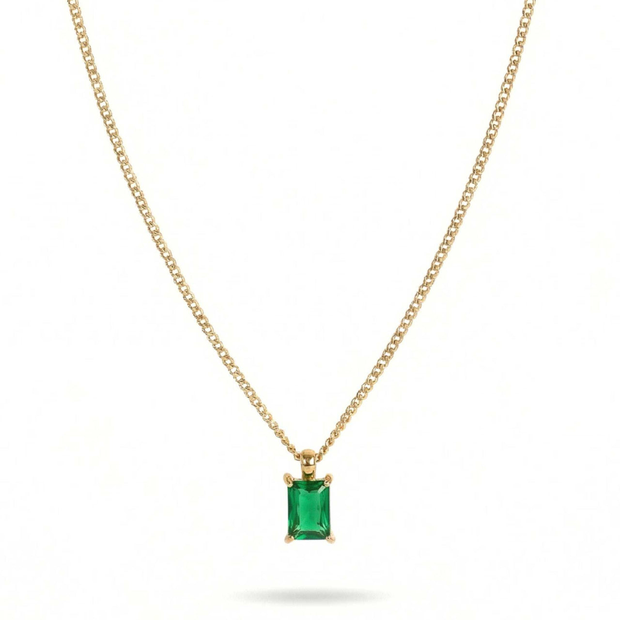Emerald Pendant Necklace by Brother & Sisters, featuring a stunning emerald gem in a classic gold setting.