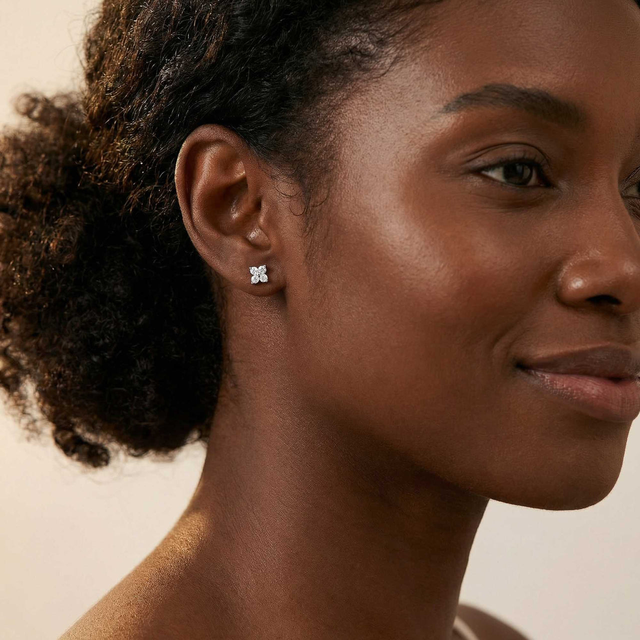 Model wearing Crystal Flower Stud Earrings by Brother & Sisters, featuring tiny flower design with sparkling zirconia.
