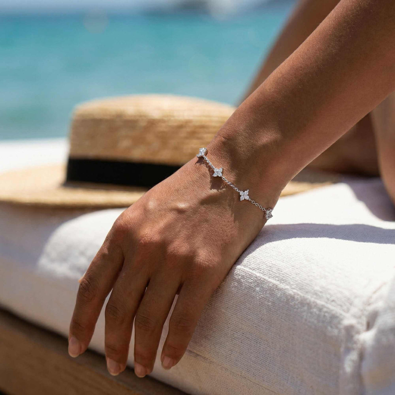 Crystal Flower Bracelet worn on wrist by a woman, showcasing five sparkling crystal flowers by Brother & Sisters.