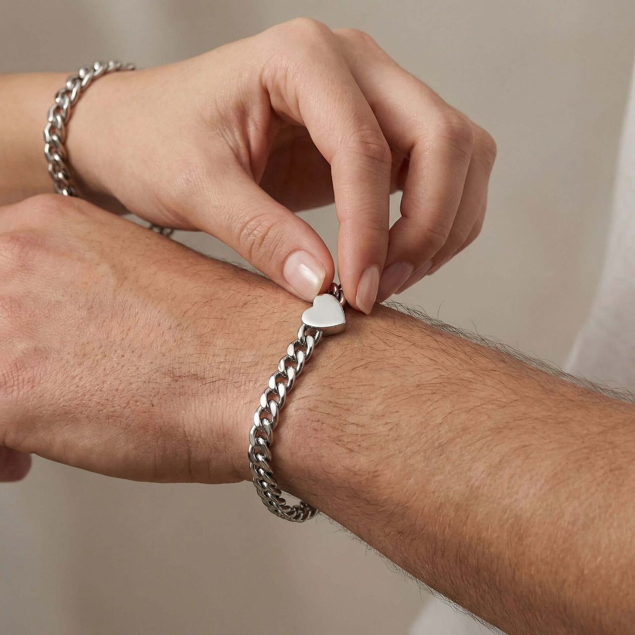 Love Couple Bracelet with polished heart on Cuban link chain by Brother & Sisters, symbolizing connection between couples.