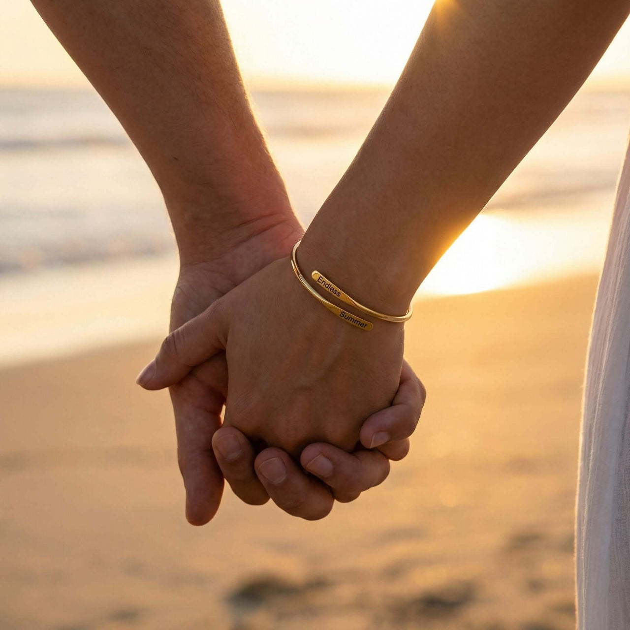 Wrap Couple Bracelet engraved with two names symbolizing love, featured by Brother & Sisters in sunset background.