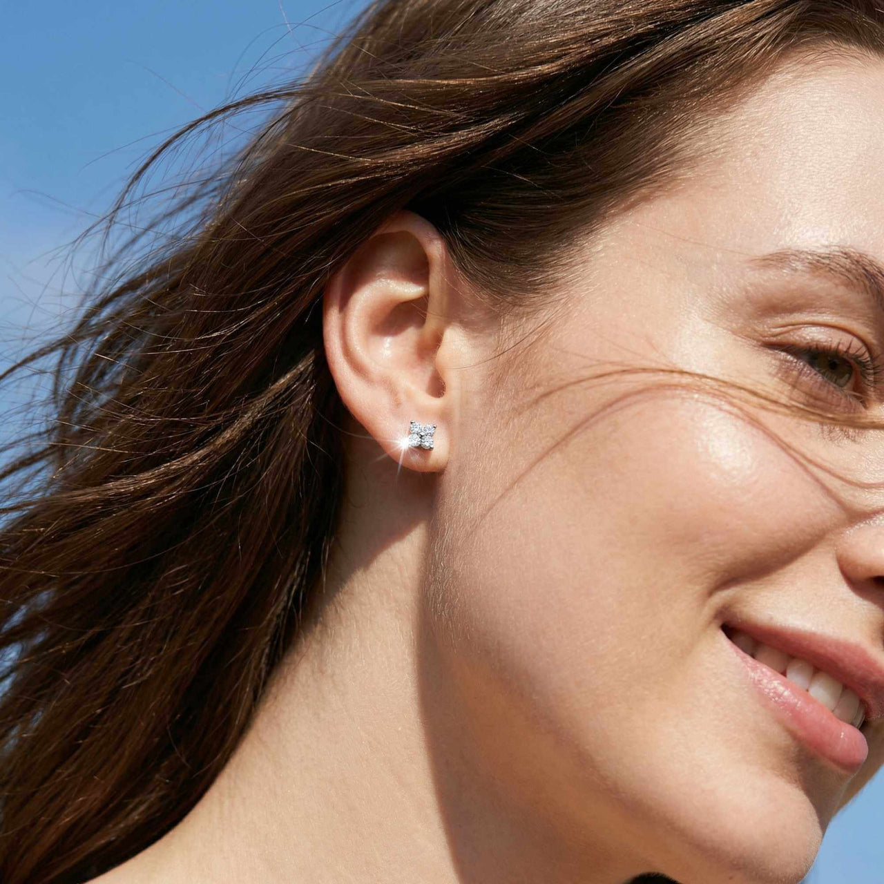 Crystal Flower Stud Earrings worn elegantly, showcasing tiny four-leaf zirconia stones by Brother & Sisters.