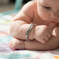 Thumbnail for Infant Bracelet on a baby's wrist featuring personalized engraving and charming design by Brother & Sisters.