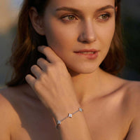 Thumbnail for Crystal Flower Bracelet by Brother & Sisters featuring five delicate crystal flowers on a woman's wrist.