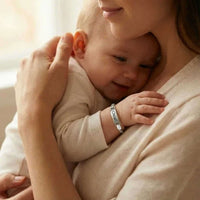 Thumbnail for Infant Bracelet worn by a smiling baby, personalized, soft, and elegant keepsake from Brother & Sisters.