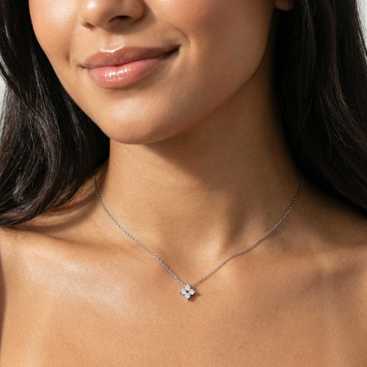 Crystal Flower necklace worn by model — dainty four-leaf zircon flower pendant for refined everyday styling