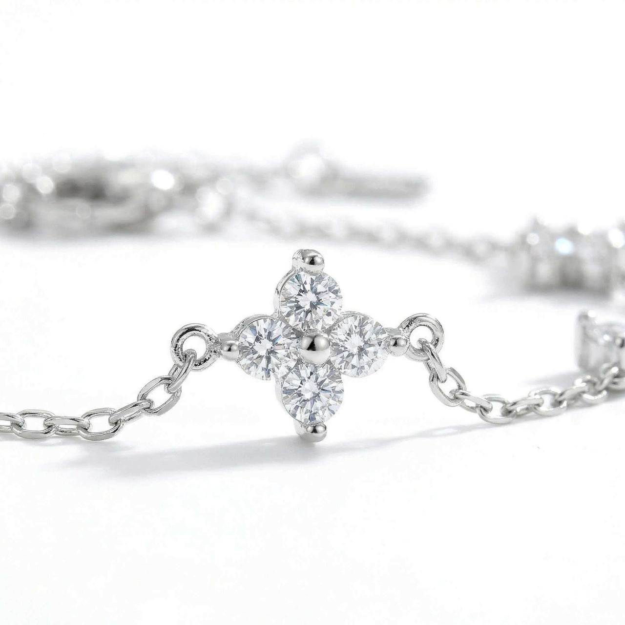 Crystal Flower Bracelet by Brother & Sisters featuring five sparkling four-leaf crystal flowers on a delicate chain.