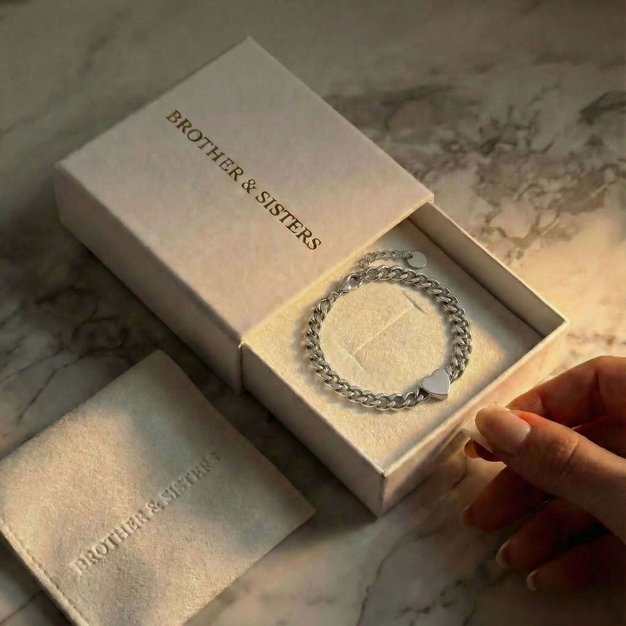 Love Couple Bracelet by Brother & Sisters in a gift box, featuring a polished heart on a Cuban link chain.
