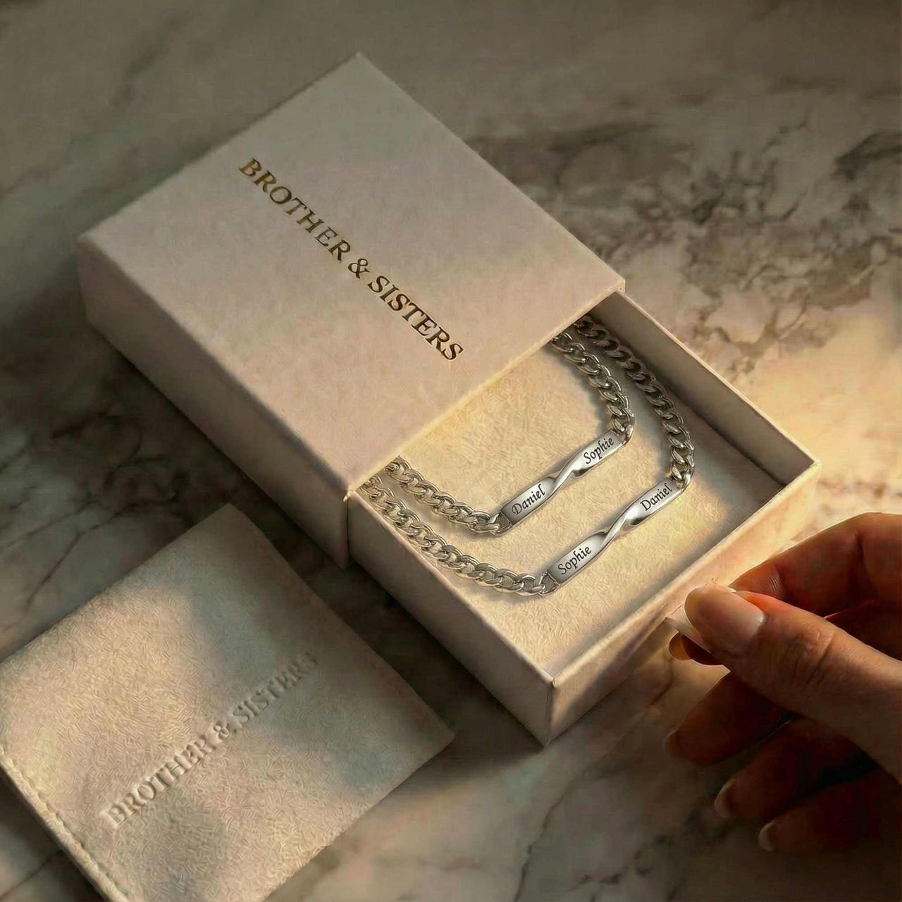 Infinity Bond Matching Bracelet in a gift box by Brother & Sisters, showcasing two name-engraved twisted bars.