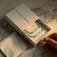 Thumbnail for Infinity Bond Matching Bracelet in a gift box by Brother & Sisters, showcasing two name-engraved twisted bars.