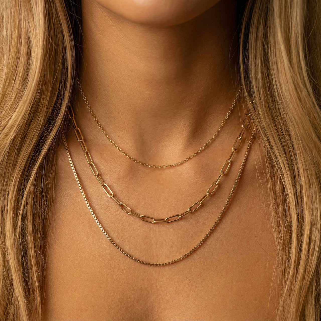 Saona Triple Layer Necklace featuring three gold chains at different lengths by Brother & Sisters.