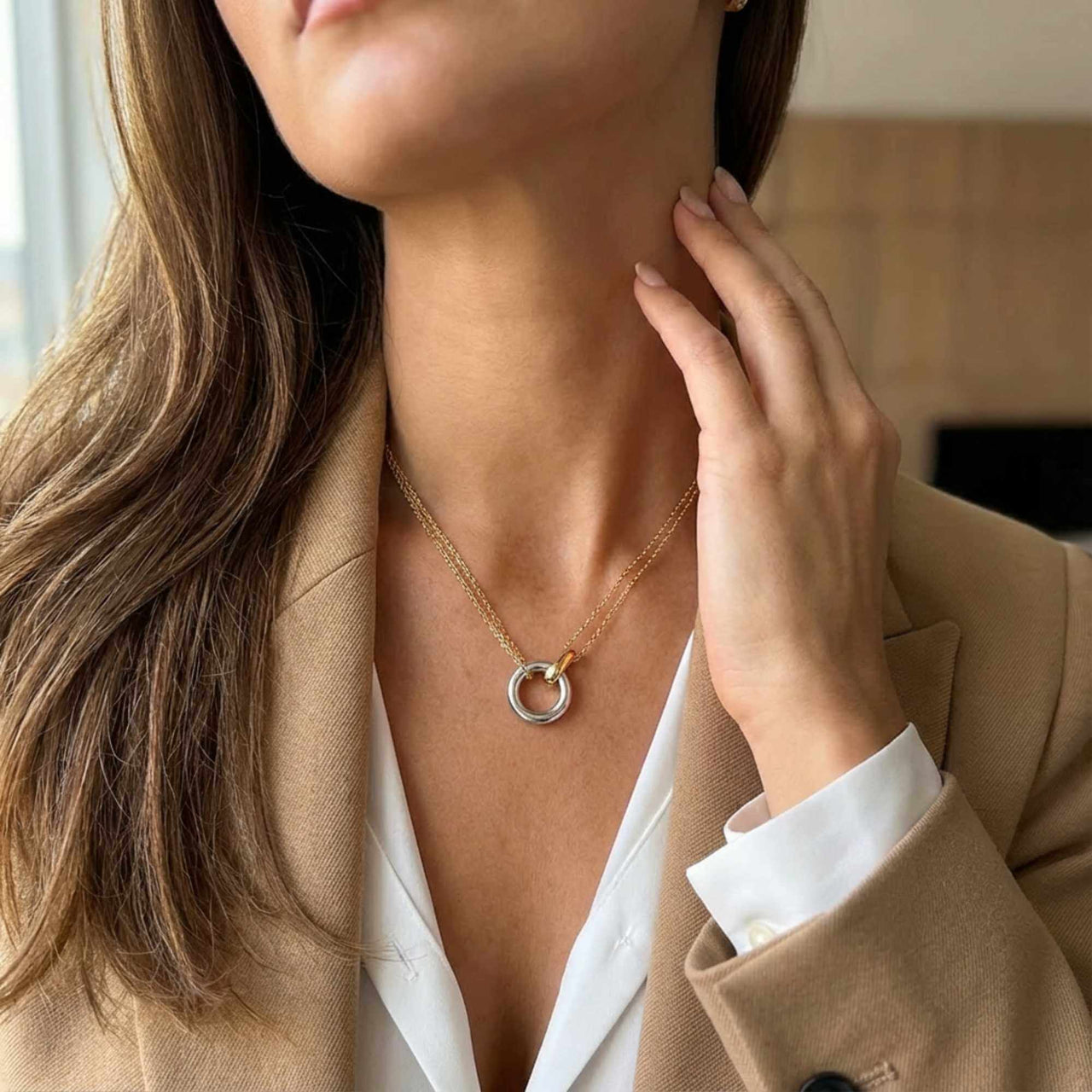 The Unity Bond necklace by Brother & Sisters featuring a silver circle and gold bar pendant.