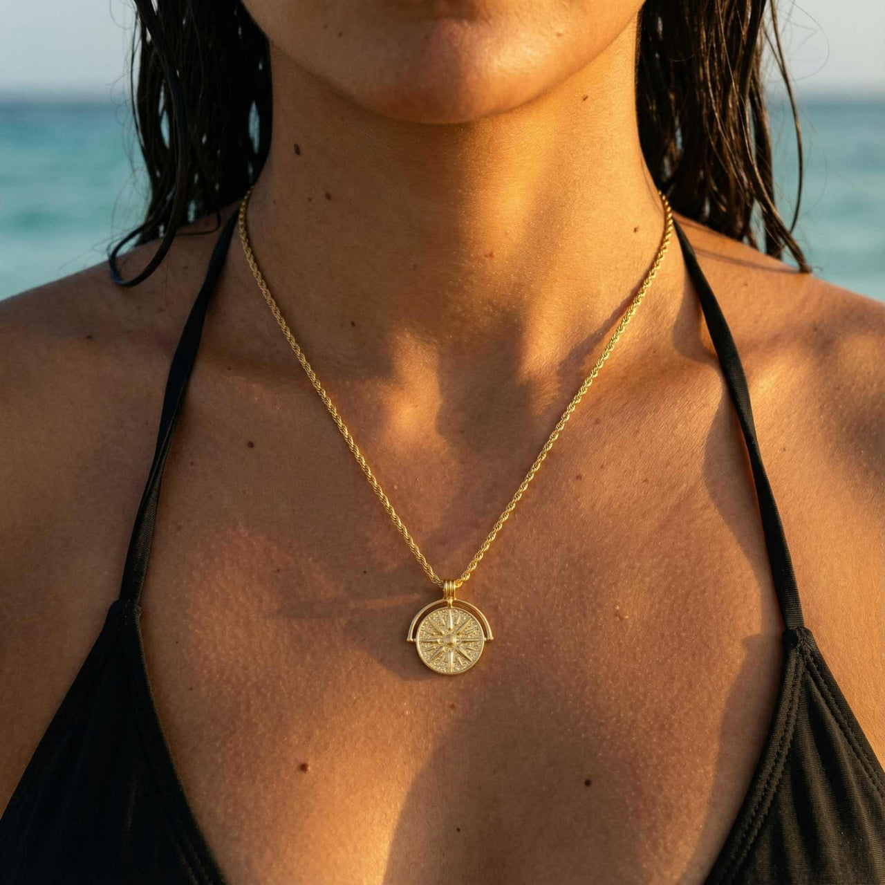 Golden Sun Necklace worn on a model, featuring a sun medallion pendant by Brother & Sisters, on a rope chain.