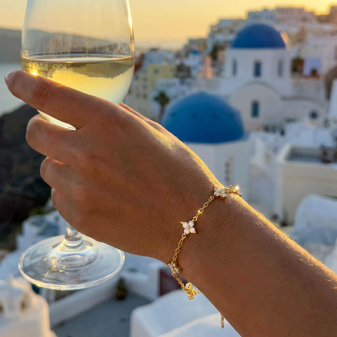 Crystal Flower Bracelet by Brother & Sisters, featuring five sparkling crystal flowers on a gold chain.