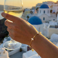 Thumbnail for Crystal Flower Bracelet by Brother & Sisters, featuring five sparkling crystal flowers on a gold chain.