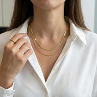 Thumbnail for The Double Luxe necklace worn by a woman, showcasing layered gold chains by Brother & Sisters.
