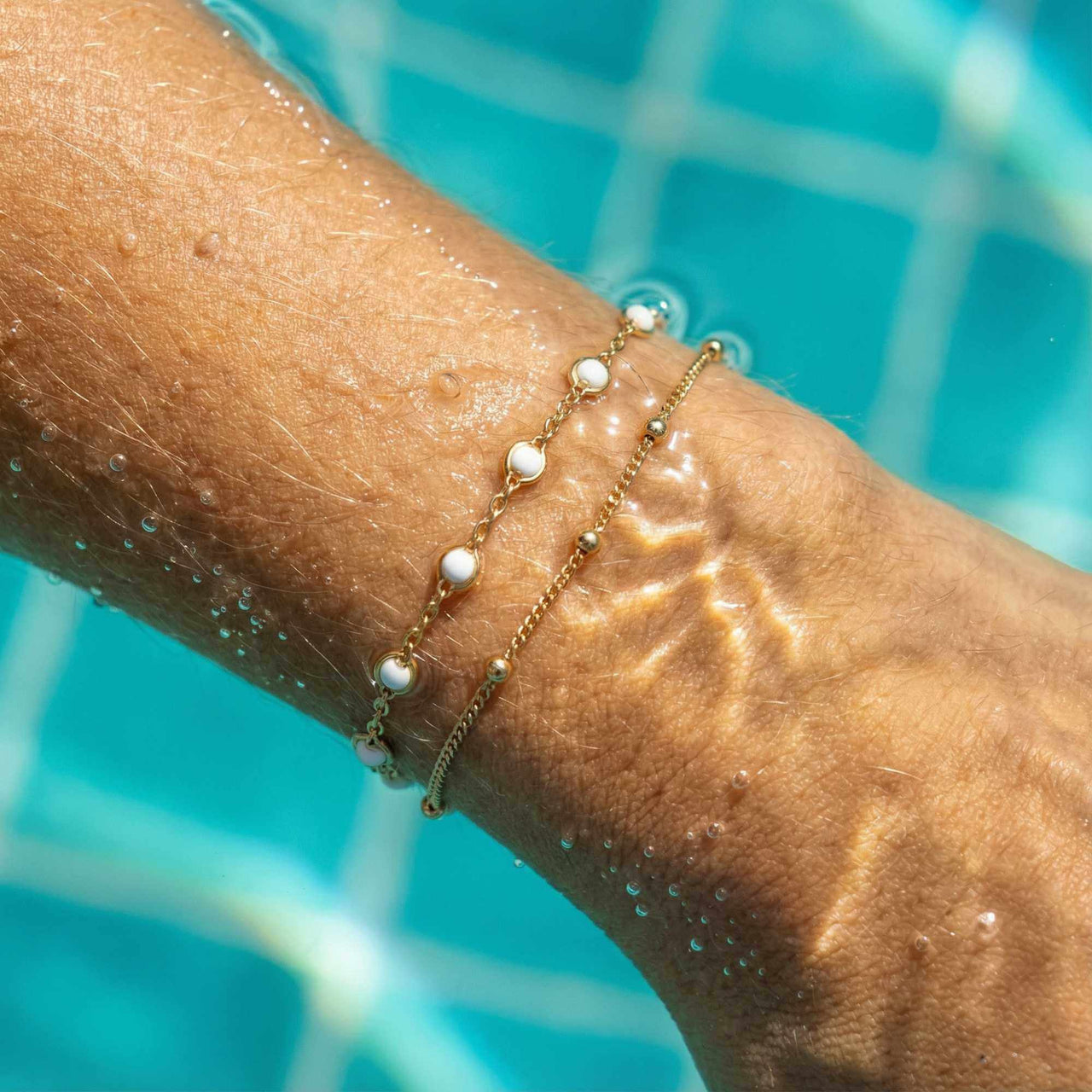 Double White Bracelet by Brother & Sisters with white enamel beads and gold links, effortlessly stylish for any occasion.