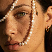 Thumbnail for Sunseeker Pearl Choker showcasing unique baroque pearls on a golden chain by Brother & Sisters.