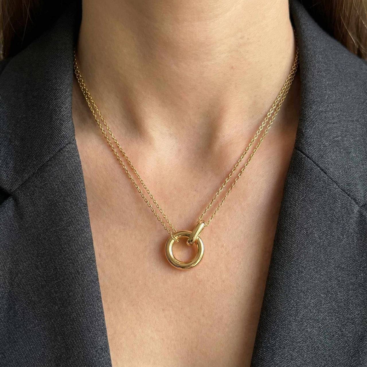 The Eternal Link double-layer necklace by Brother & Sisters, featuring interlocking circle pendant and delicate gold chains.