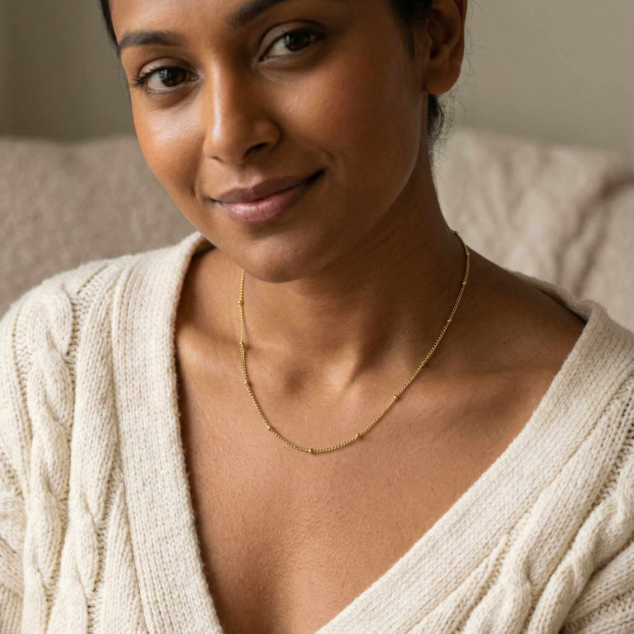 Julia Beaded Chain Necklace worn by a woman, featuring tiny golden beads by Brother & Sisters.