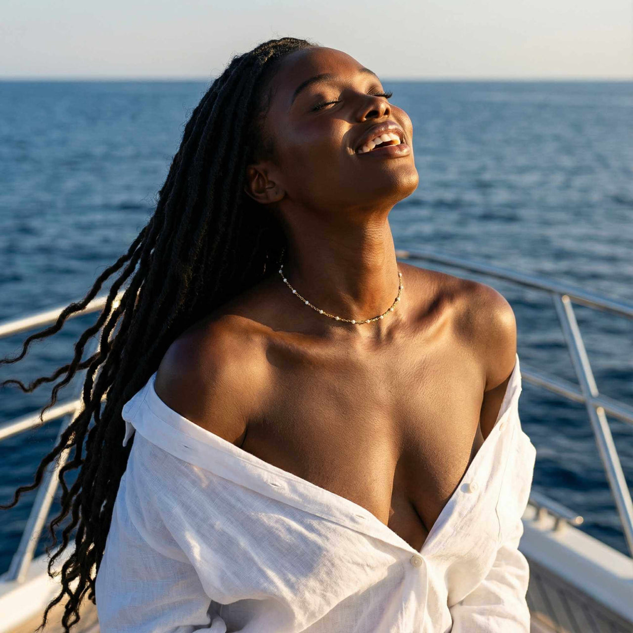 White Beaded Choker worn by model on a boat with ocean background, featuring gold accents and tiny white enamel beads, Brother & Sisters