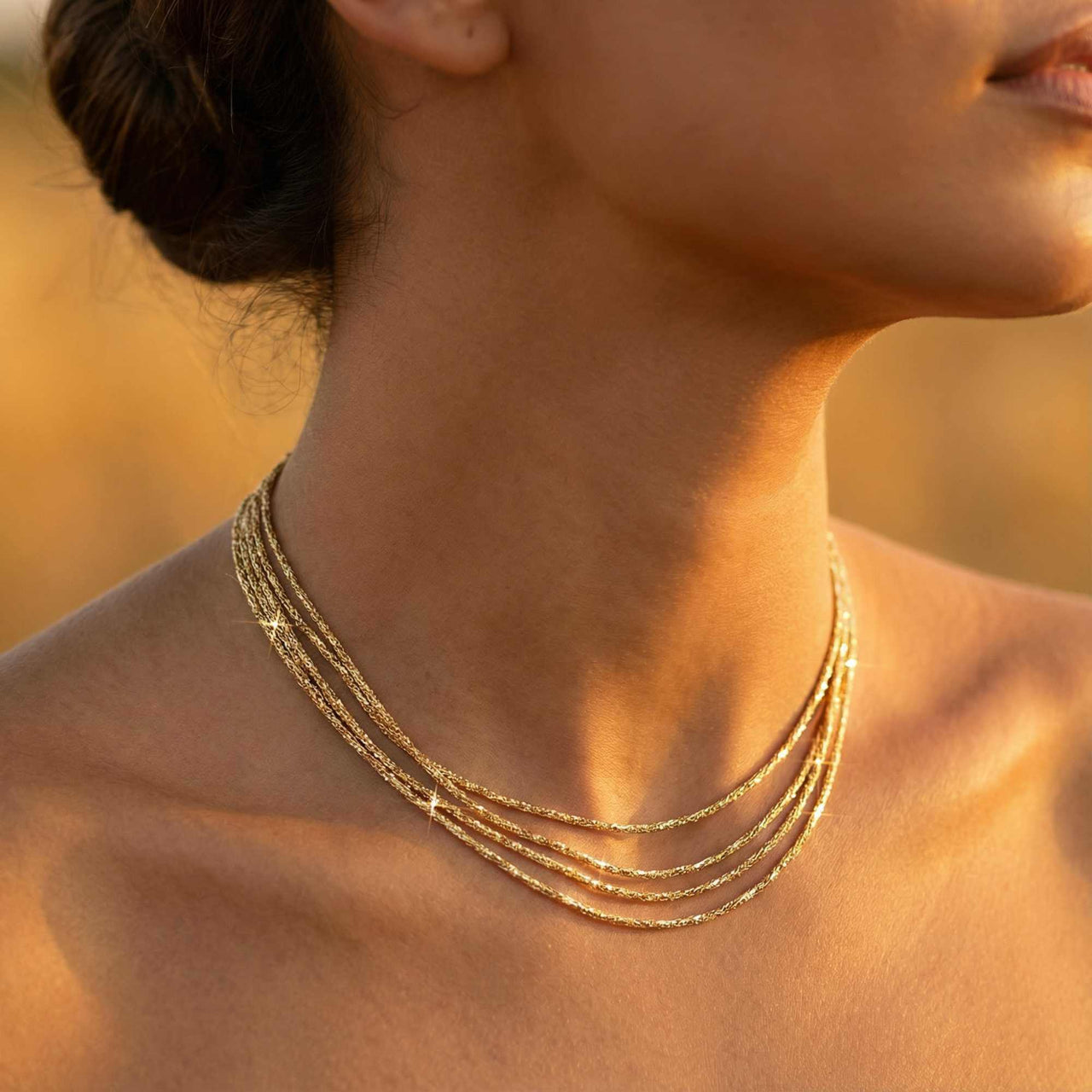 Riviera Layered Choker by Brother & Sisters showcases four delicate gold chains for an effortless layered look.