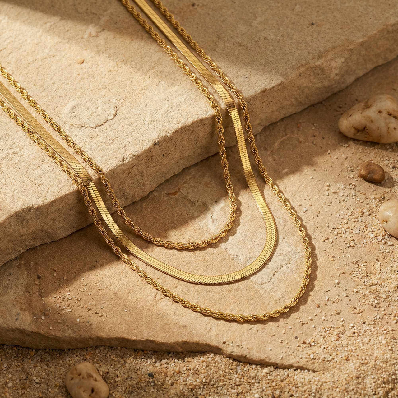 The Double Luxe, a sophisticated double-chain necklace by Brother & Sisters, featuring gold herringbone and rope chains.