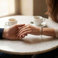 Thumbnail for Wrap Couple Bracelet showcasing couple holding hands, featuring delicate design by Brother & Sisters.
