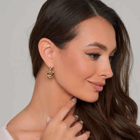 Thumbnail for Aurora Heart Hoops worn by a woman, showcasing elegant gold earrings from Brother & Sisters.