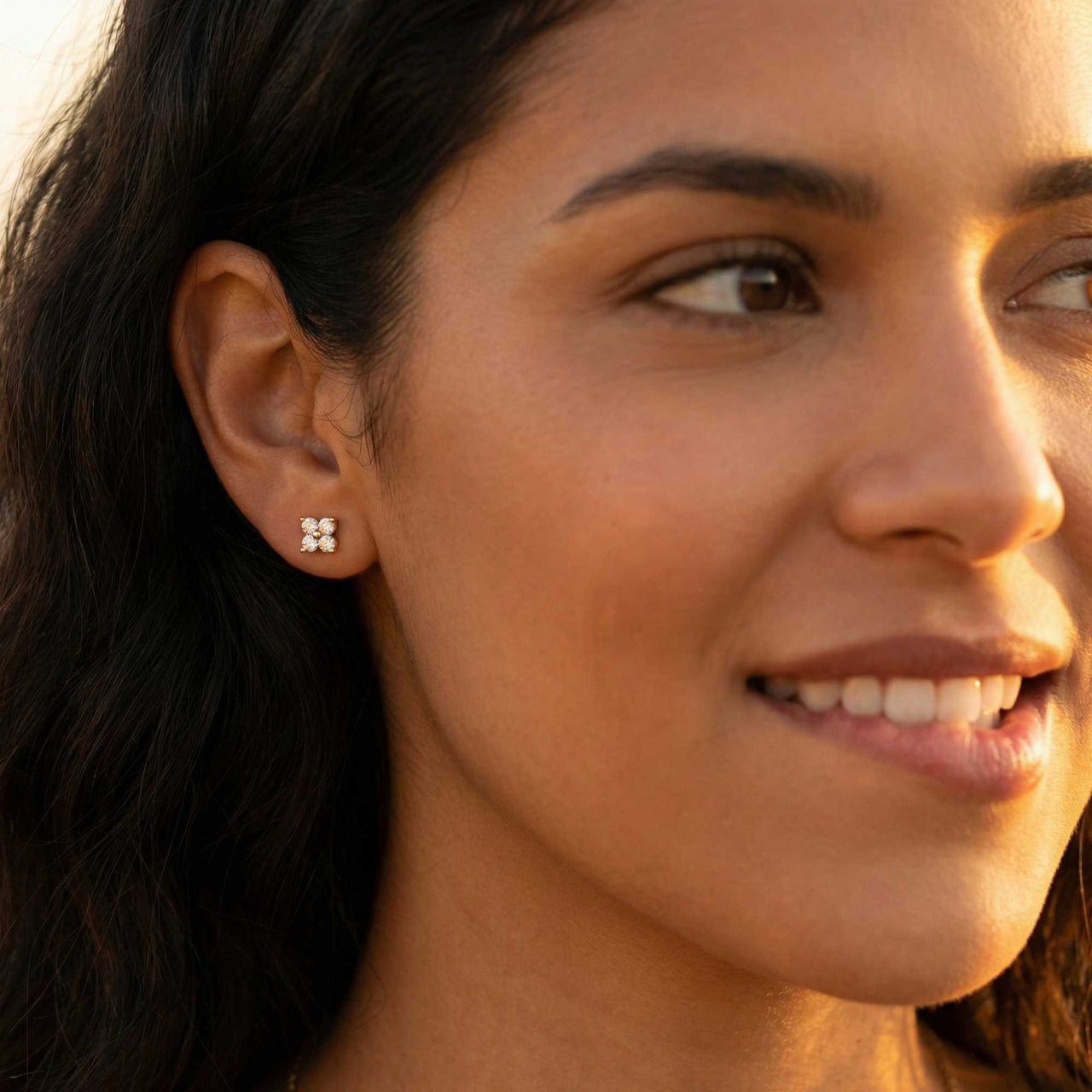 Crystal Flower Stud Earrings worn by a woman, featuring four-leaf crystal design by Brother & Sisters, adding subtle sparkle.