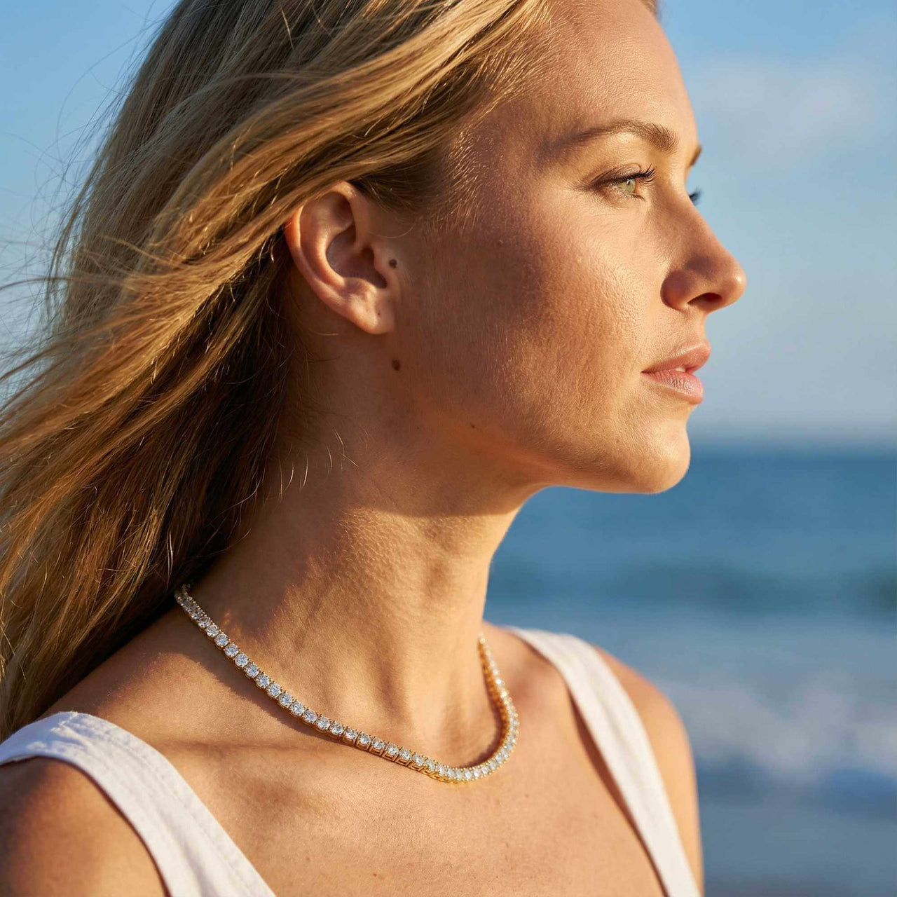 Isolde Tennis Necklace worn by a model, featuring diamond simulants set in 18K gold, by Brother & Sisters.