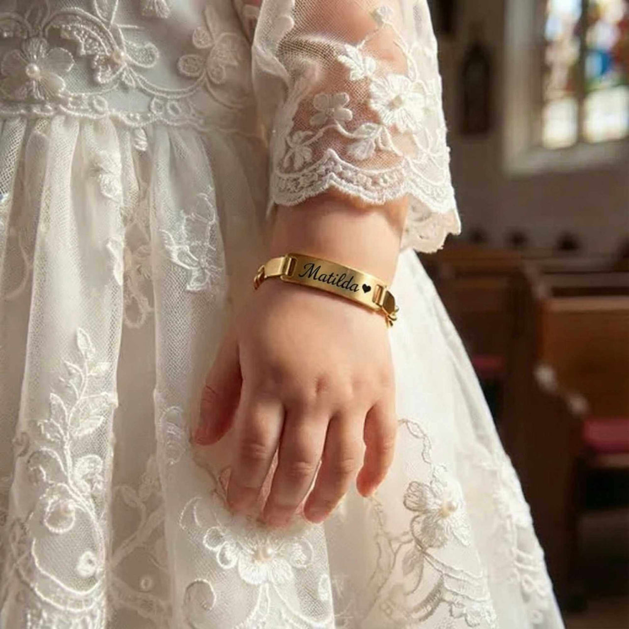 Infant Bracelet worn by child in elegant dress, featuring personalized name 'Matilda' by Brother & Sisters.