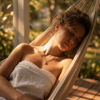 Thumbnail for Astra Teardrop Necklace worn by a woman relaxing in a hammock with natural sunlight.