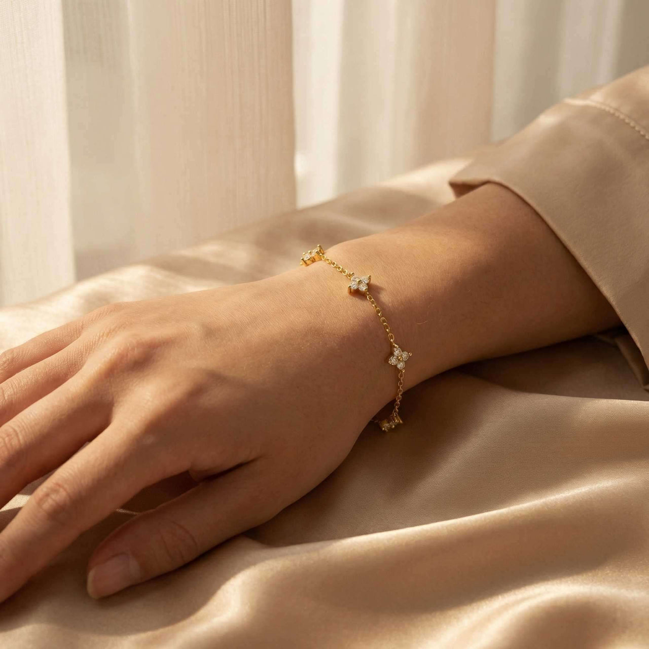 Crystal Flower Bracelet featuring five sparkling crystal flowers by Brother & Sisters on a delicate gold chain.